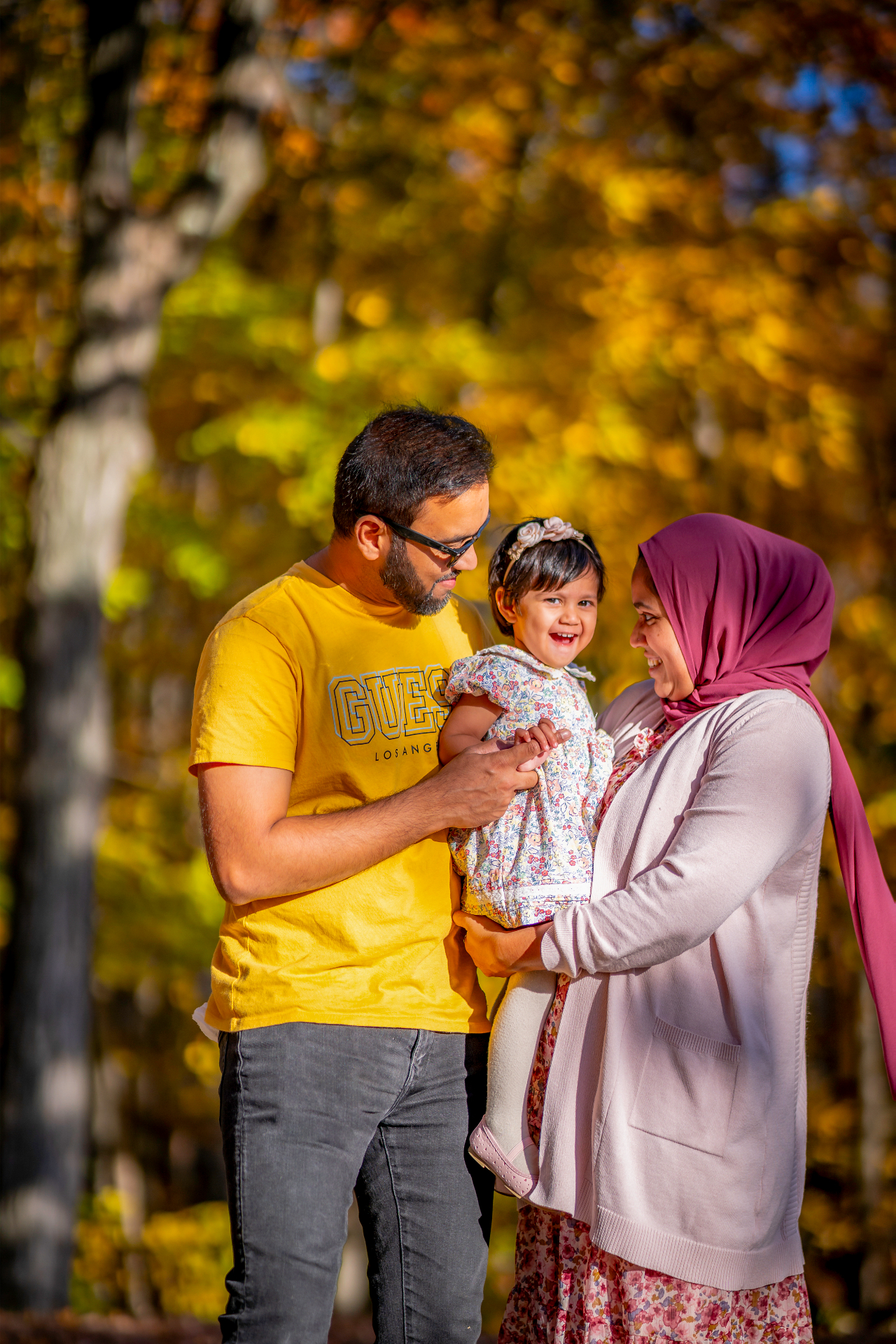 Faatiha with her parents in the autumn leaves
