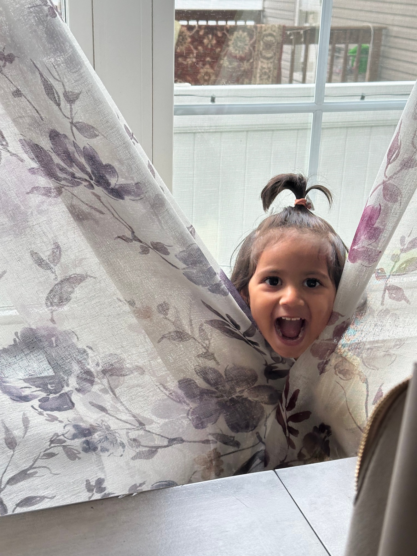 Faatiha peeking through curtains